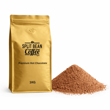 Gold packaging of Split Bean Coffee Co. Premium Hot Chocolate with a pile of hot chocolate powder on a white background.