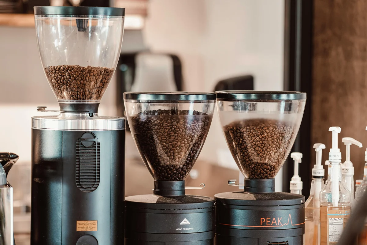 Roasted coffee beans in a commercial coffee grinder