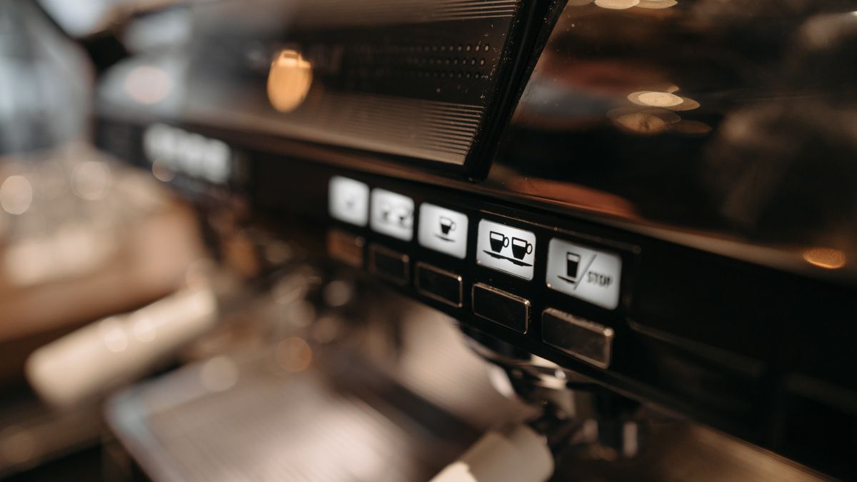 A bean to cup machine pouring a latte at the touch of a button
