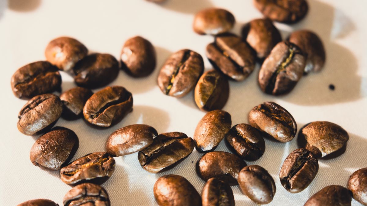 Close up of roasted coffee beans, the running cost behind an office coffee machine