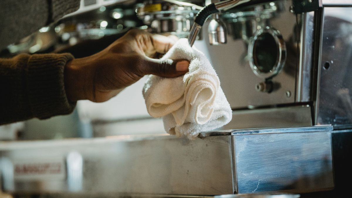 Cleaning a commercial coffee machine, the routine that decides how long an office machine lasts
