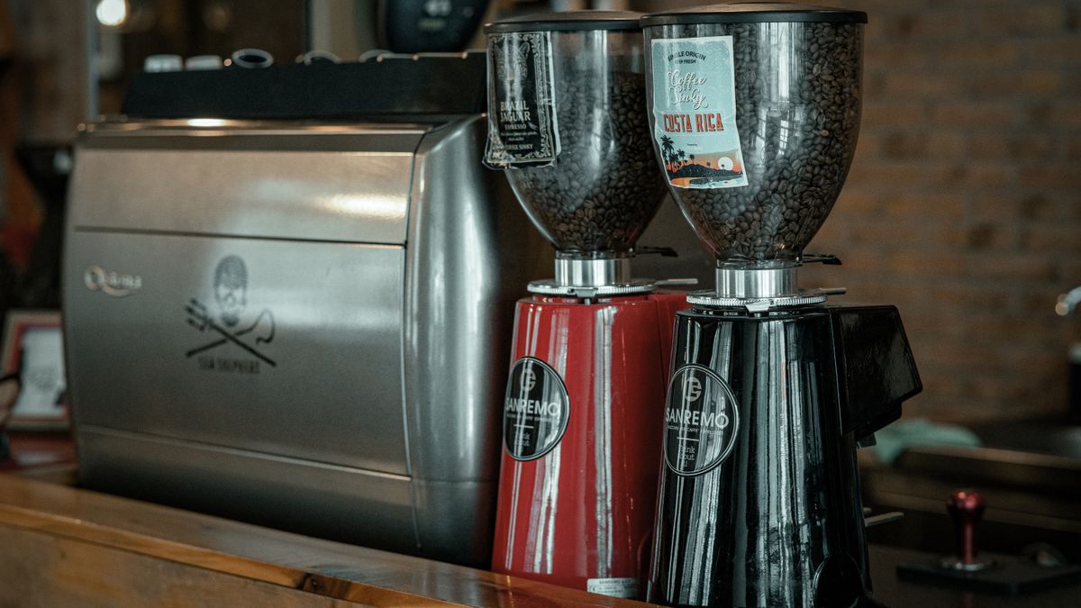 A commercial coffee grinder machine on a cafe counter