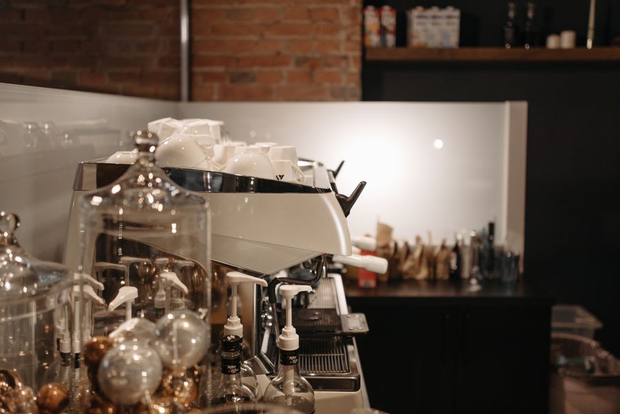 Commercial espresso machine producing a shot of espresso in a professional setting