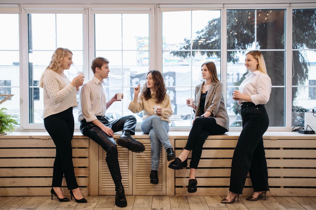 Office workers having a coffee break together in a modern workplace setting