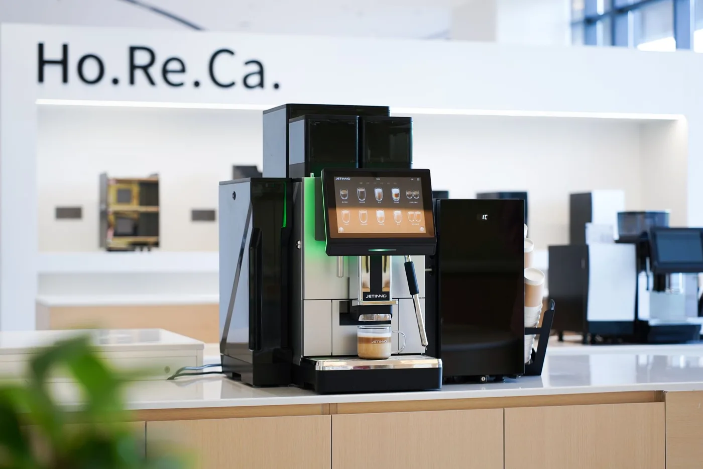 Jetinno JL38 bean to cup coffee machine pouring a latte on a business counter