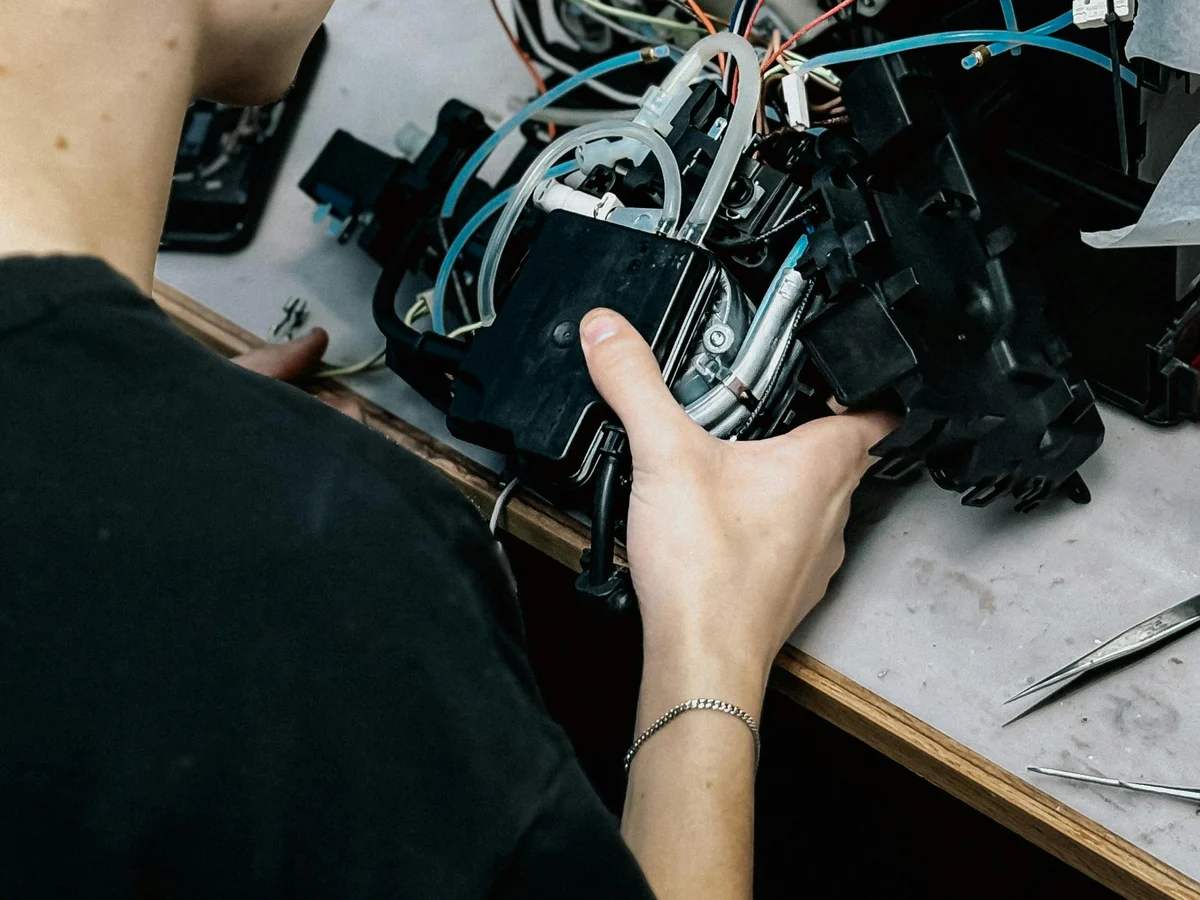 Technician servicing a commercial coffee machine